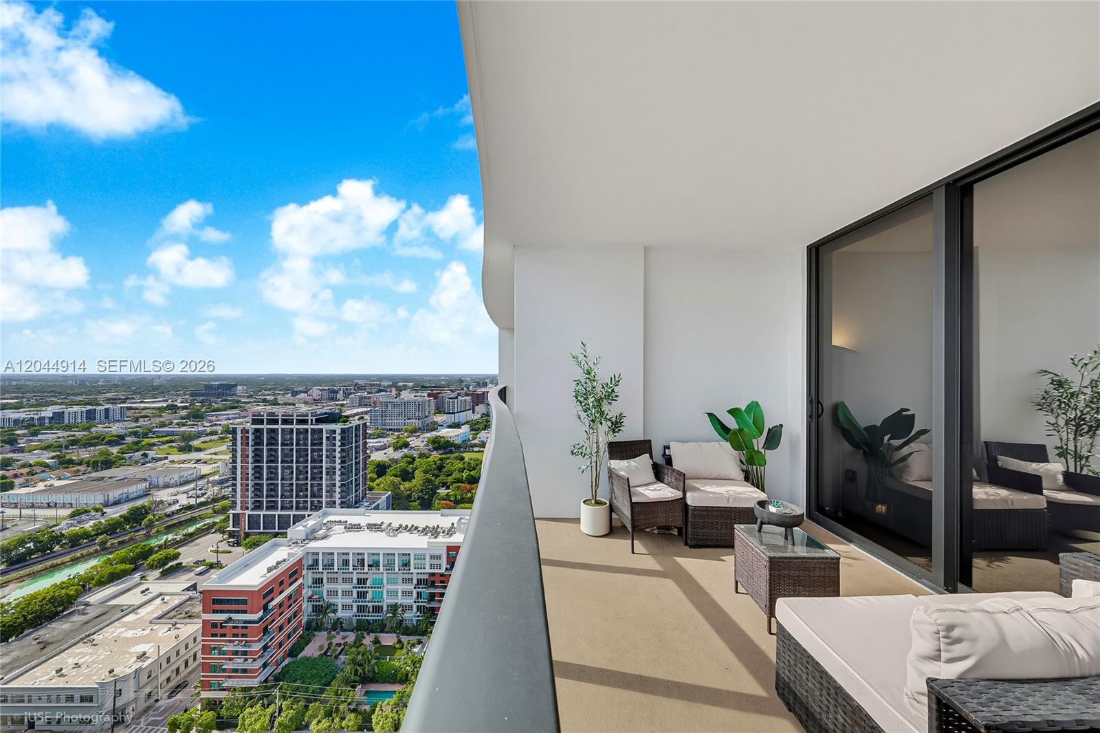 A high-rise balcony features outdoor furniture and a panoramic view of the surrounding city — 1600 NE 1st Ave # 2814, Miami FL 33132, MIAMI, FL