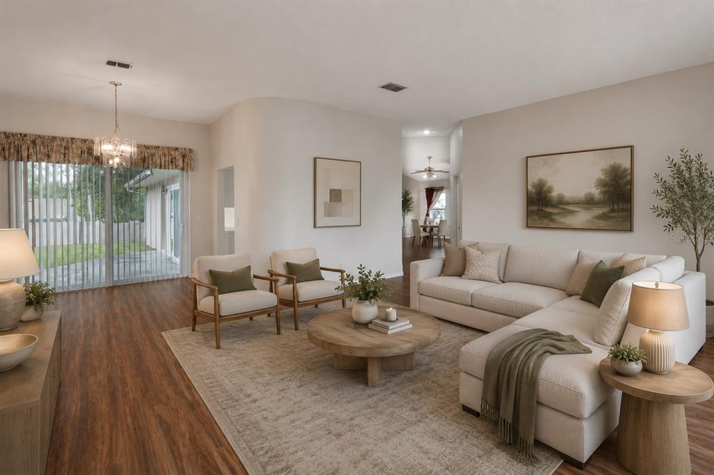 A living room features a sectional sofa, two armchairs, a round coffee table, and flooring — 10435 CRESTFIELD DRIVE, RIVERVIEW, FL