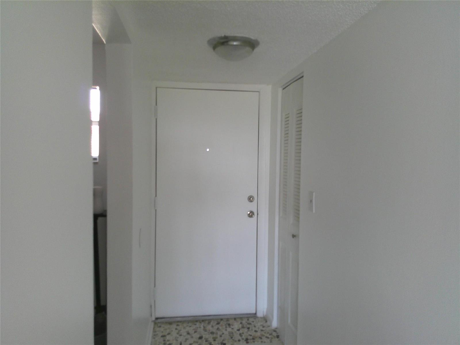 A white interior door and a louvered closet door are located in a small hallway — 403 NW 68th Avenue # 519, Plantation FL 33317, PLANTATION, FL