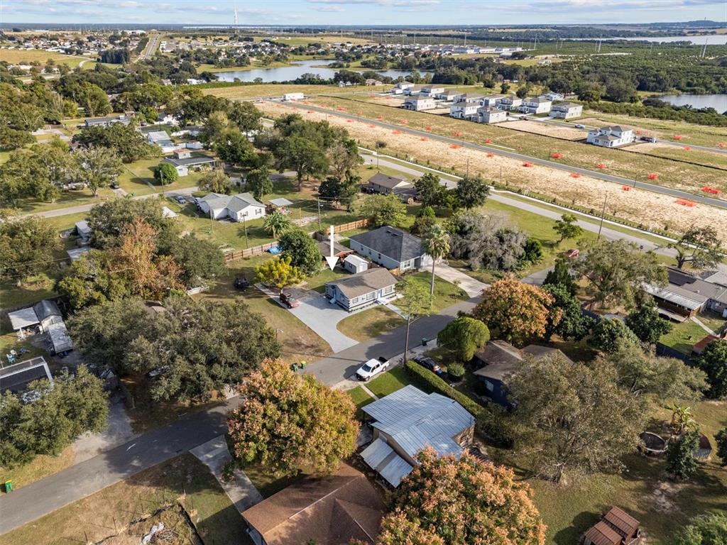An aerial view shows a single-story house with a driveway and a detached shed — 513 5TH STREET, DUNDEE, FL