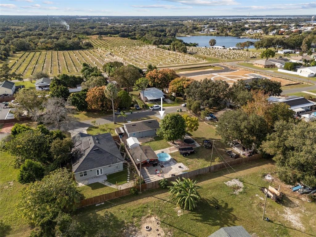 An aerial view shows a residential property with a house, pool, and fenced backyard — 513 5TH STREET, DUNDEE, FL