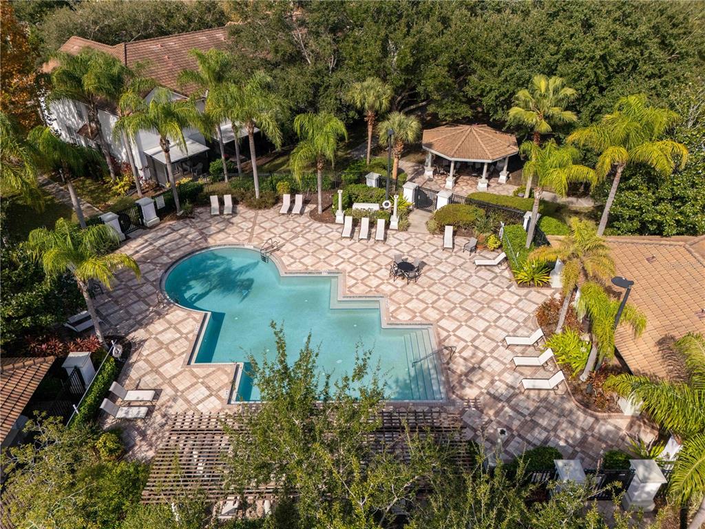 An aerial view of a swimming pool surrounded by a paved patio, palm trees, and gazebo — 6979 SPERONE STREET, ORLANDO, FL