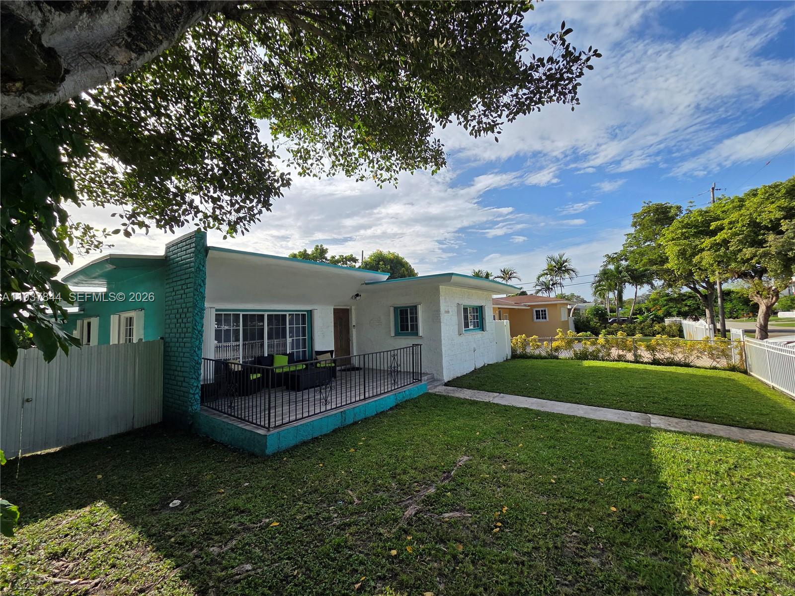 A turquoise and white house features a front porch with a black metal railing — 13895 NE 11th Ave, North Miami FL 33161, NORTH MIAMI, FL