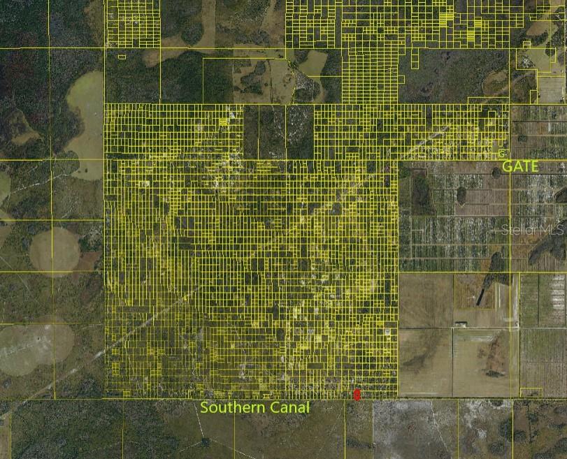 This is a satellite map showing a large grid of land parcels near a canal — SUBURBAN ESTS SEC 31...5224 002N, ST CLOUD, FL