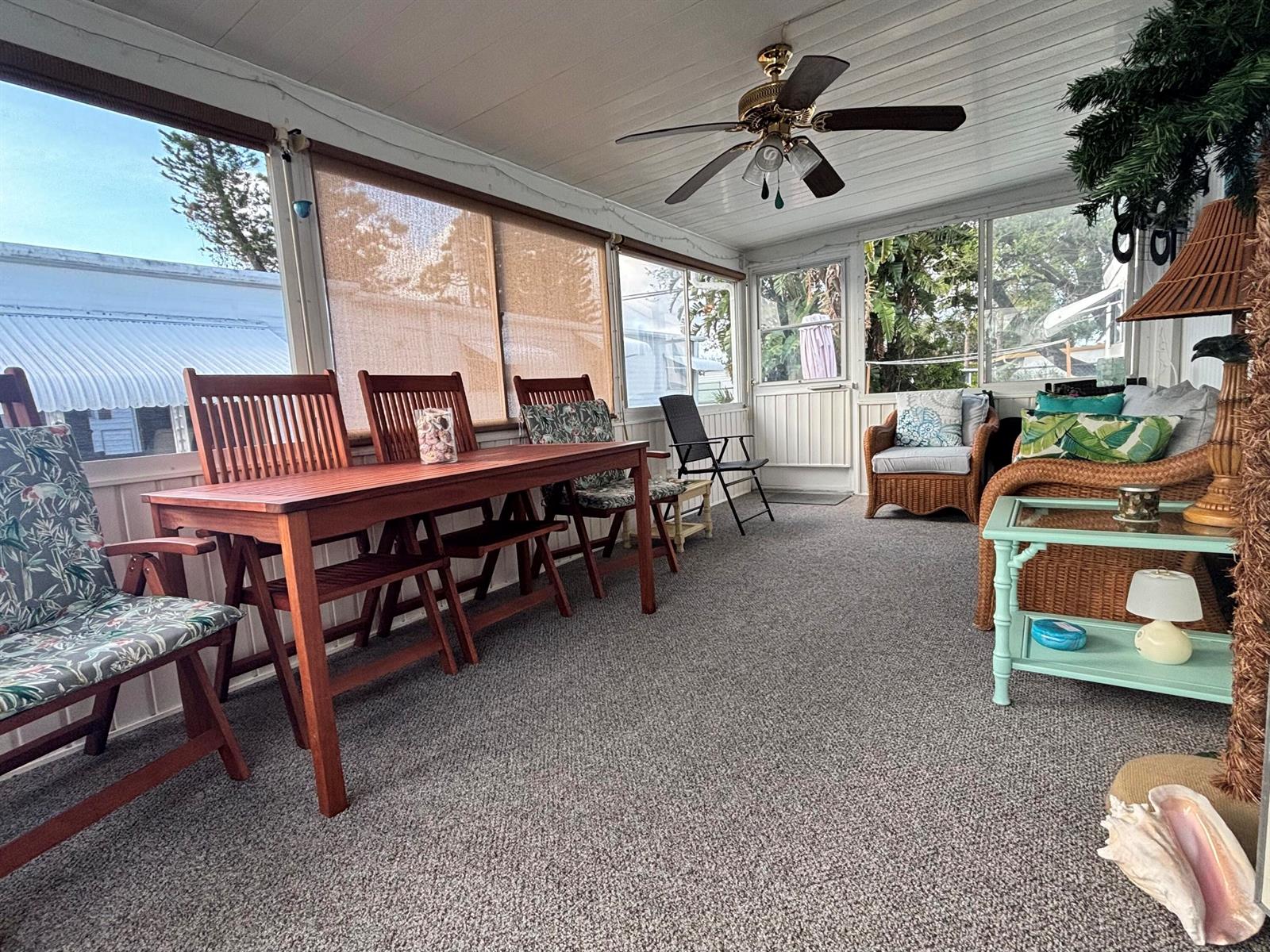 A sunroom features a wooden dining set, wicker furniture, carpeted floors, and a ceiling fan — 4121 88th Court S, Boynton Beach FL 33436, BOYNTON BEACH, FL