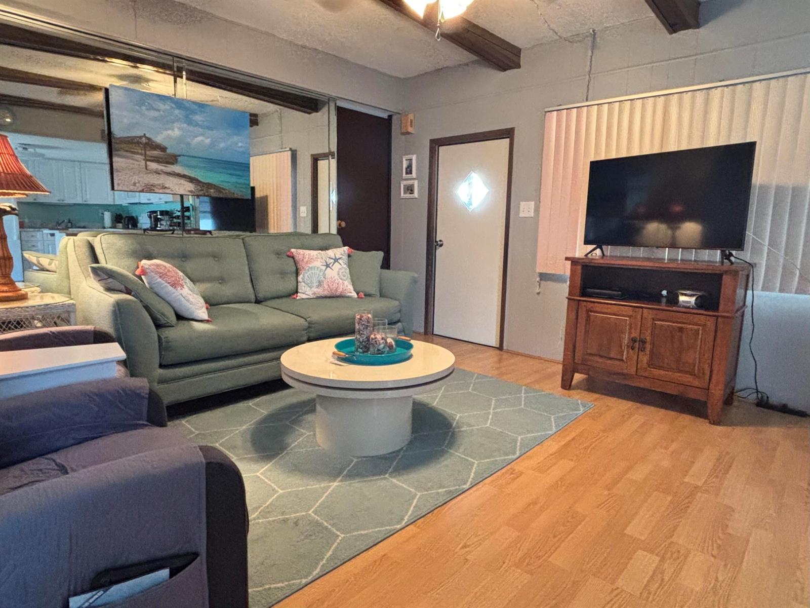 A living room features a green sofa, a round coffee table, and a television console — 4121 88th Court S, Boynton Beach FL 33436, BOYNTON BEACH, FL