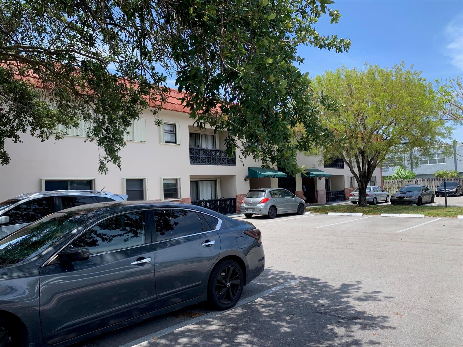 A two-story apartment building with a red tile roof and a parking lot in front — 1721 NW 15th Vista, Boca Raton FL 33432, BOCA RATON, FL