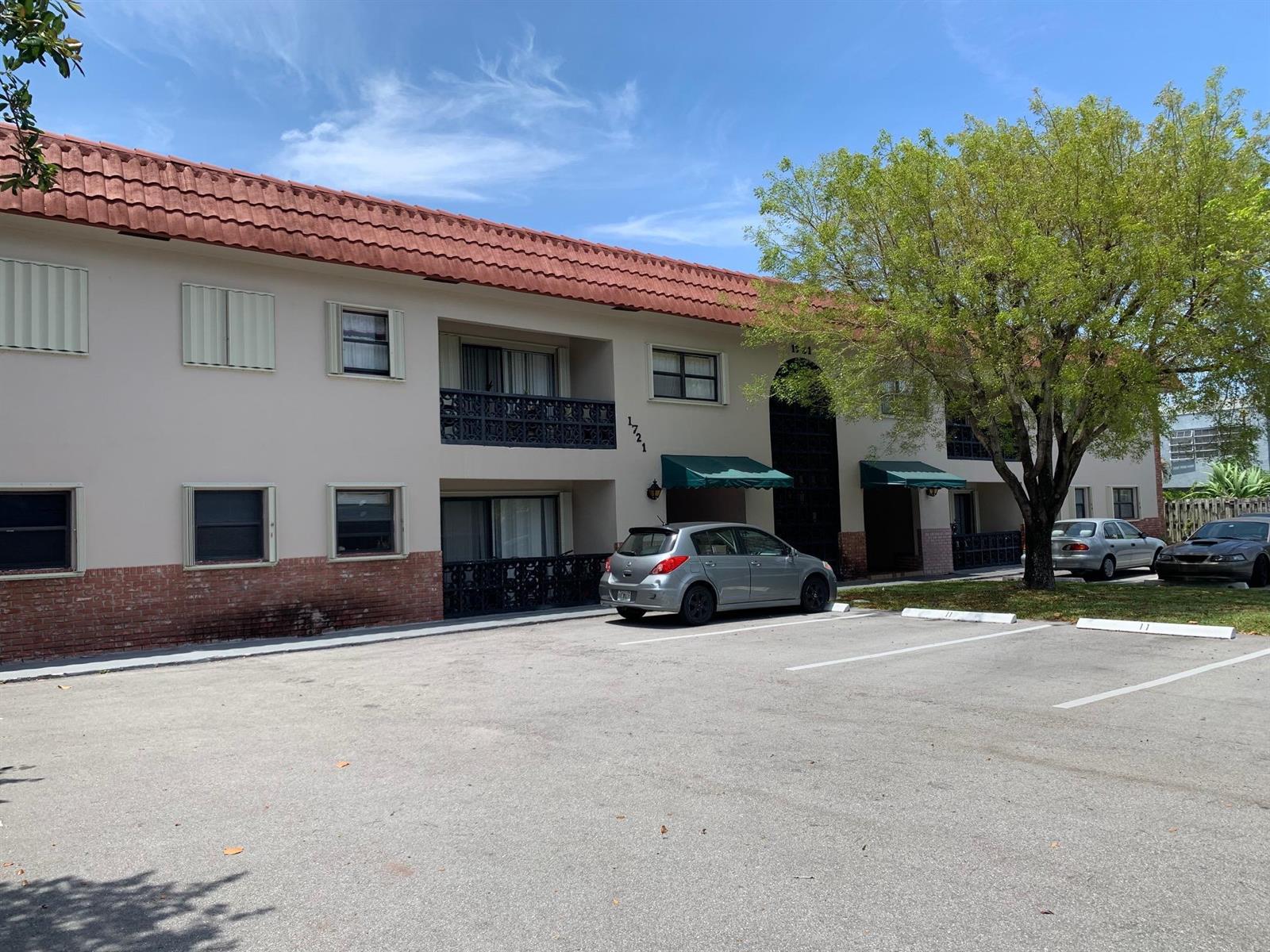 A two-story apartment building with a red tile roof and a parking lot in front — 1721 NW 15th Vista, Boca Raton FL 33432, BOCA RATON, FL