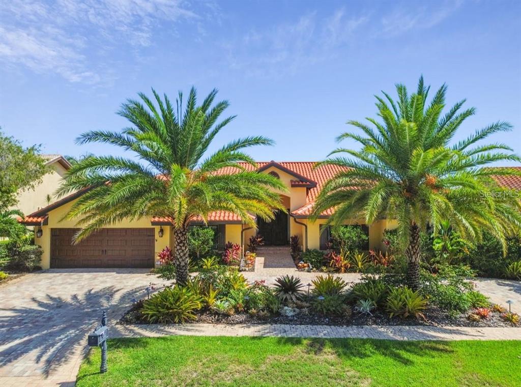 A single-story house with a tile roof, two palm trees, and a paved driveway — 9805 COMPASS POINT WAY, TAMPA, FL