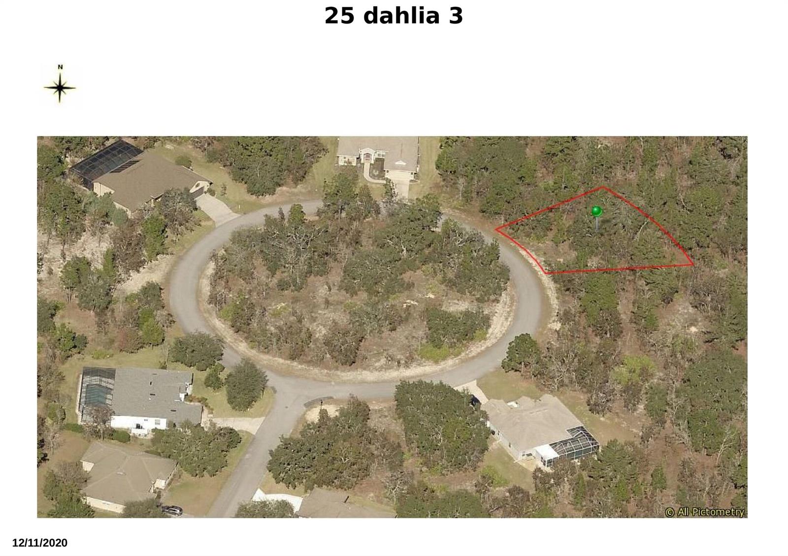 An aerial view shows a vacant, wooded lot outlined in red within a residential cul-de-sac — 25 Dahlia Court N, FL 34446, FL