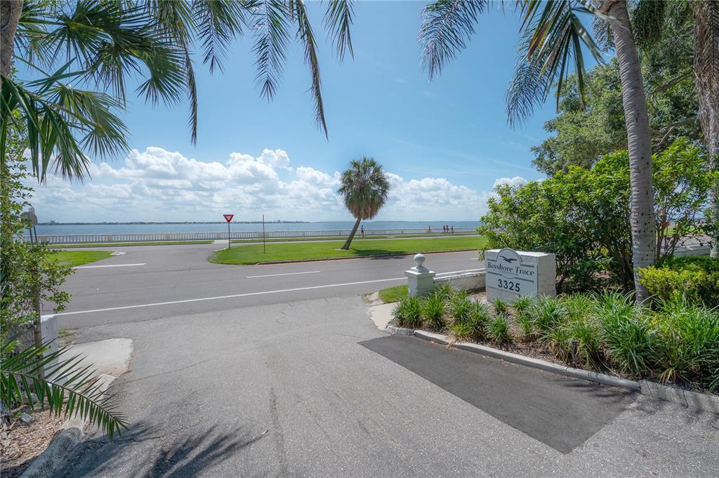 A view of a waterfront street entrance with a sign for Bayshore Trace — 3325 BAYSHORE BOULEVARD UNIT A17, TAMPA, FL