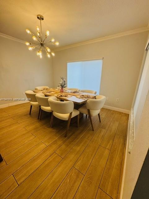 A dining room features a modern sputnik chandelier, a wooden table, and six white chairs — 10919 NW 67th Ter, Doral FL 33178, DORAL, FL
