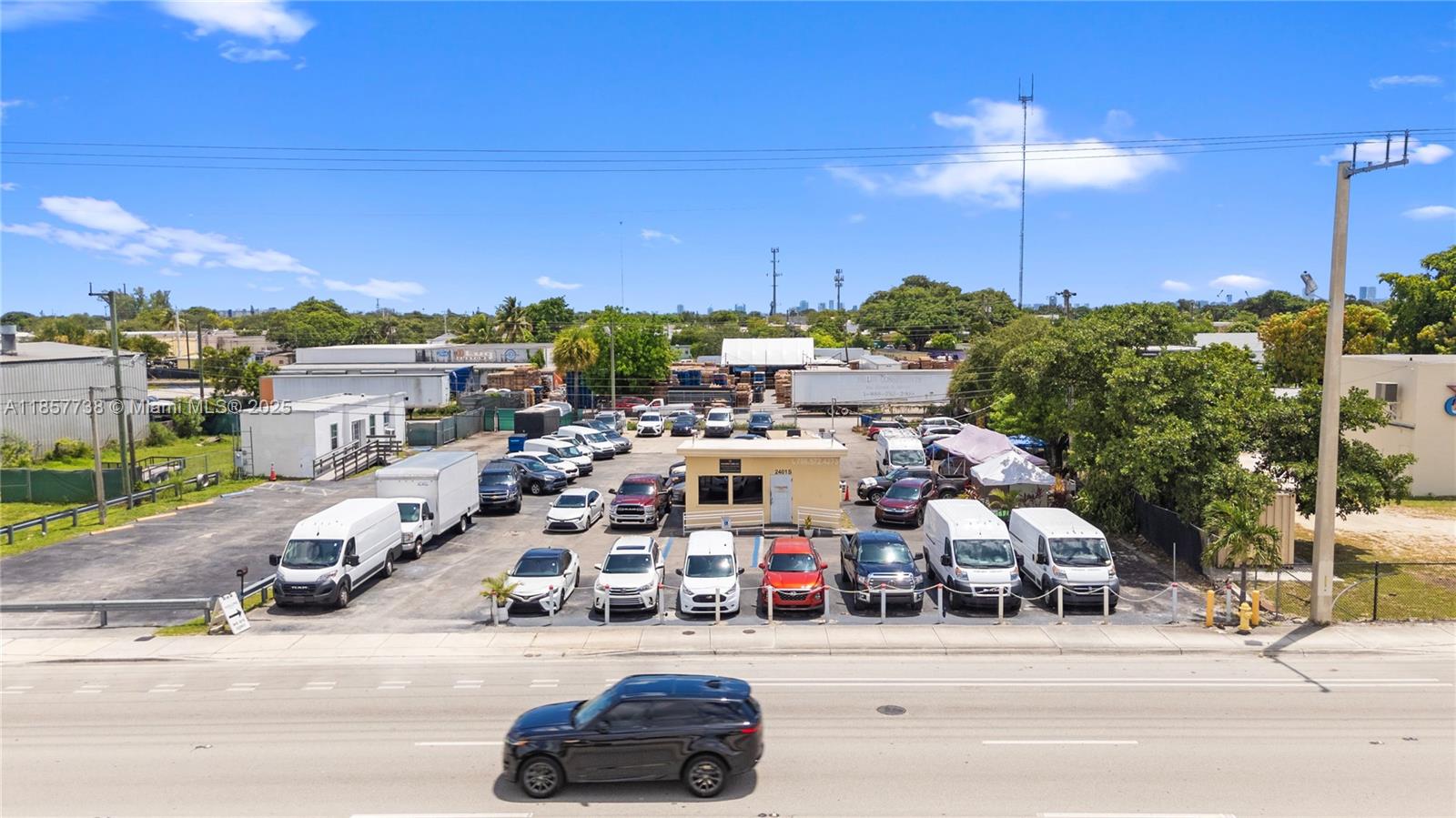 An aerial view shows a commercial car lot with a small office building and vehicles — 2401 S State Road 7, West Park FL 33023, WEST PARK, FL