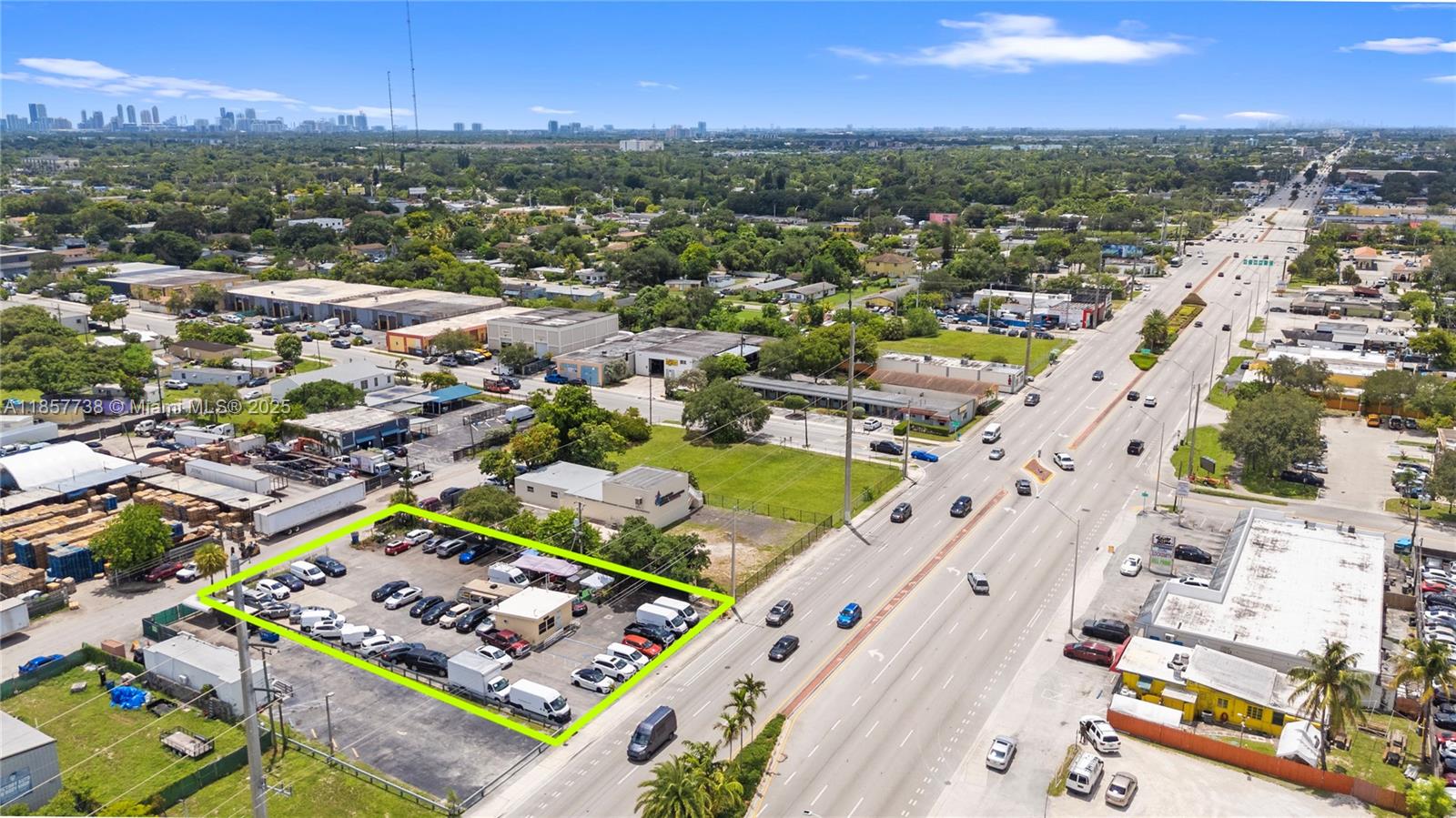An aerial view shows a fenced commercial parking lot with vehicles next to a highway — 2401 S State Road 7, West Park FL 33023, WEST PARK, FL