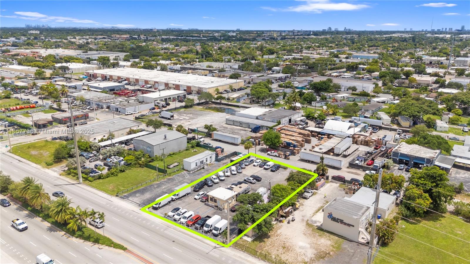 An aerial view shows a fenced commercial lot with a small building and parked vehicles — 2401 S State Road 7, West Park FL 33023, WEST PARK, FL