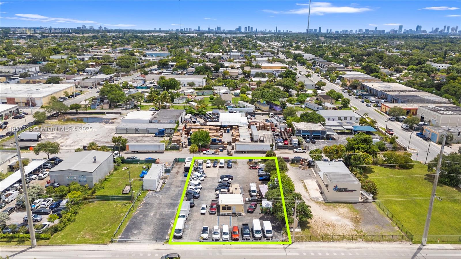 An aerial view shows a fenced commercial lot with a small building and parked vehicles — 2401 S State Road 7, West Park FL 33023, WEST PARK, FL