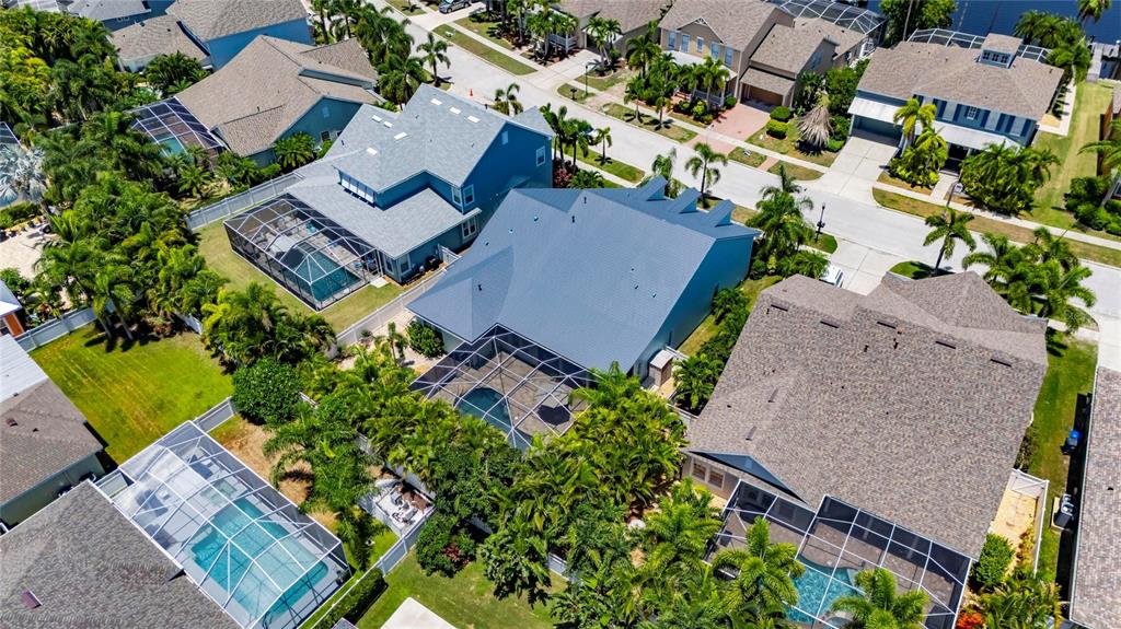 An aerial view shows several suburban houses with screened-in swimming pools and palm trees — 5226 BRIGHTON SHORE DRIVE, APOLLO BEACH, FL
