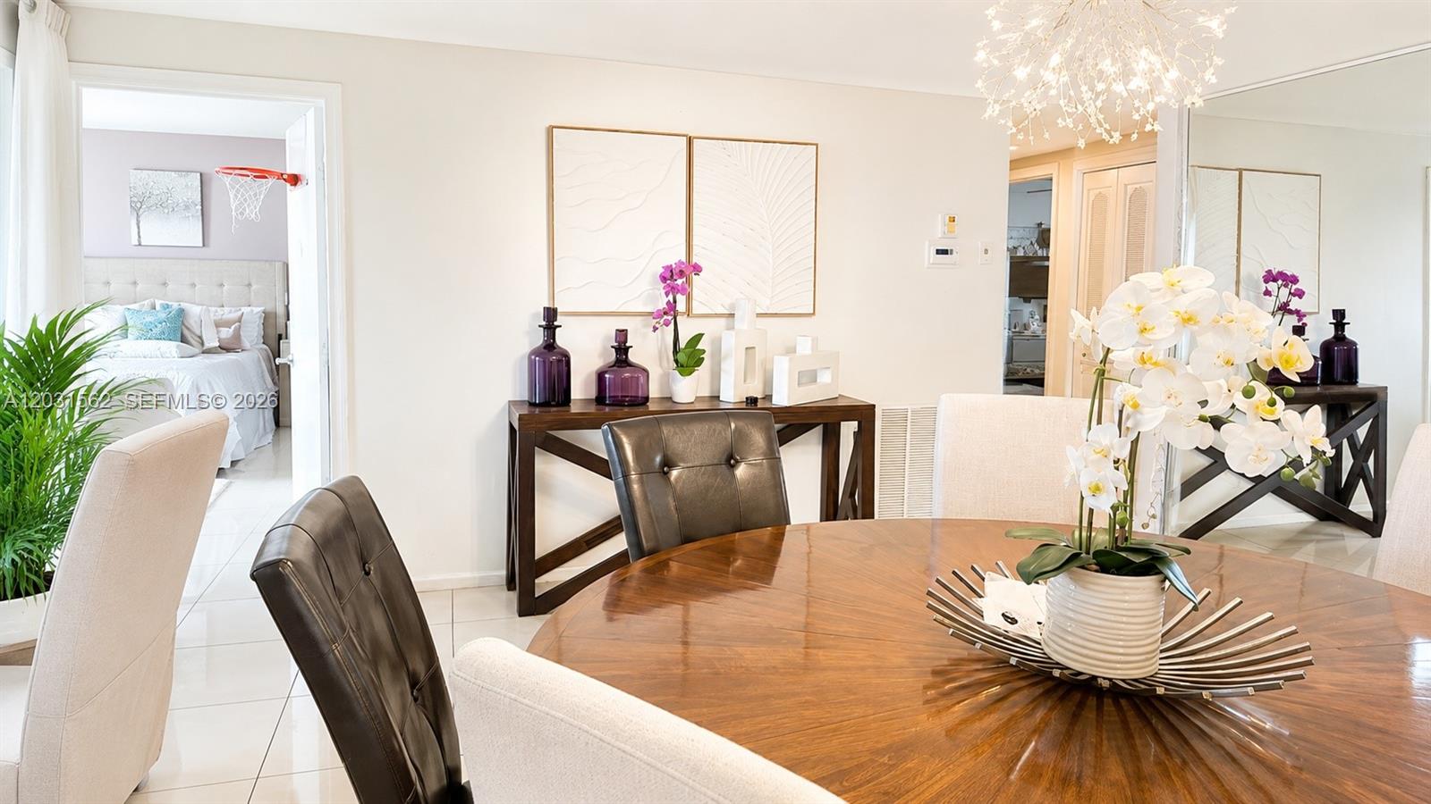 A dining room features a round wooden table, upholstered chairs, and a console table — 4570 NW 18th Ave # 506, Deerfield Beach FL 33064, DEERFIELD BEACH, FL