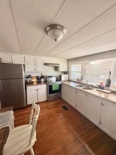 A kitchen with white cabinets, stainless steel appliances, and wood flooring — 13494 61ST WAY N, CLEARWATER, FL