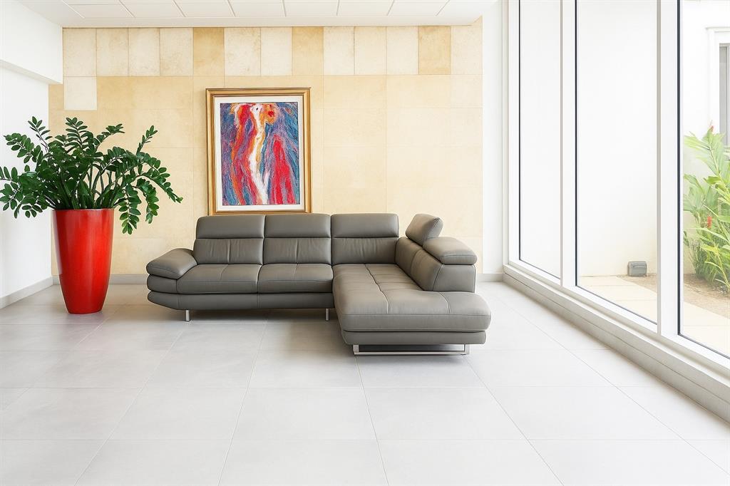A modern living room features a grey sectional sofa, a red planter, and abstract wall art — 3103 AVE. ISLA VERDE COND. CONDESA DEL MAR UNIT 1402, ISLA VERDE, PR