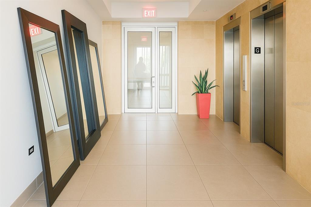 A hallway with tile floors, two elevators, a potted plant, and three leaning mirrors — 3103 AVE. ISLA VERDE COND. CONDESA DEL MAR UNIT 1402, ISLA VERDE, PR