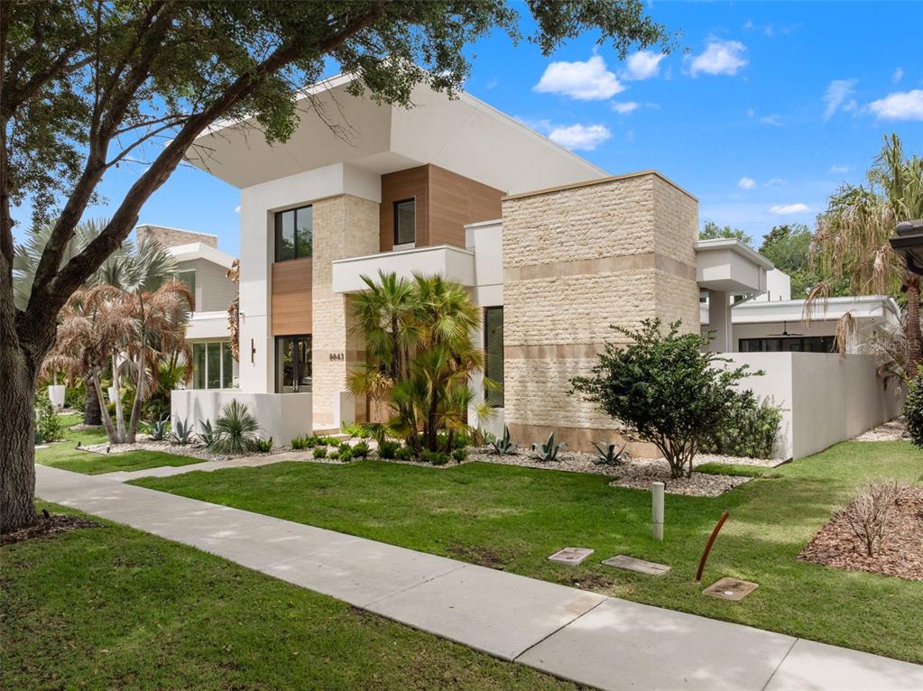 A modern home exterior features a swimming pool, a spa, and a covered patio area — 8643 FARTHINGTON WAY, ORLANDO, FL