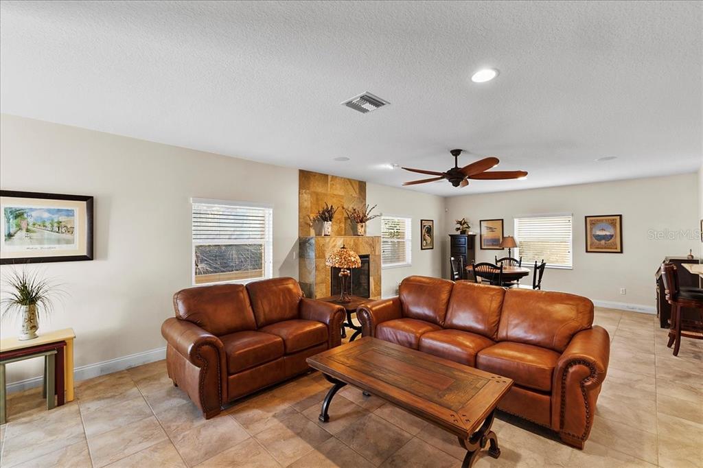 A white wooden deck overlooks a sandy beach and the ocean under a blue sky — 5609 S ATLANTIC AVENUE, NEW SMYRNA BEACH, FL