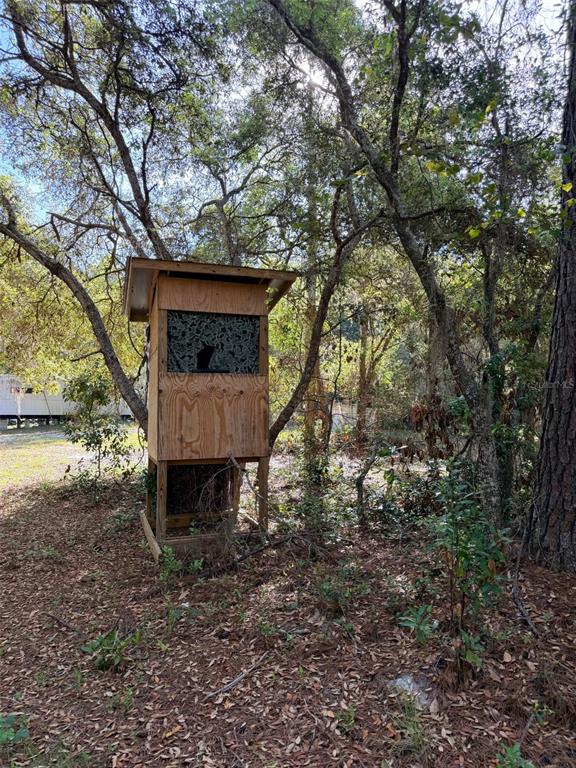 A wooden hunting blind stands among trees in a wooded area — 6650 NW 110TH AVENUE, CHIEFLAND, FL