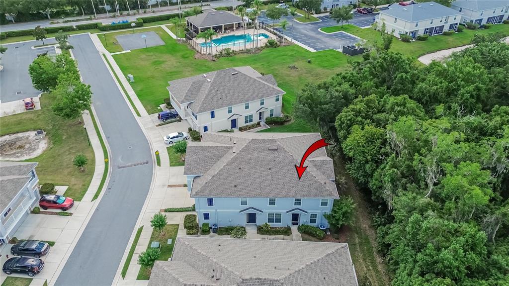An aerial view shows a multi-unit residential building with a red arrow pointing toward it — 714 ASHENTREE DRIVE, PLANT CITY, FL