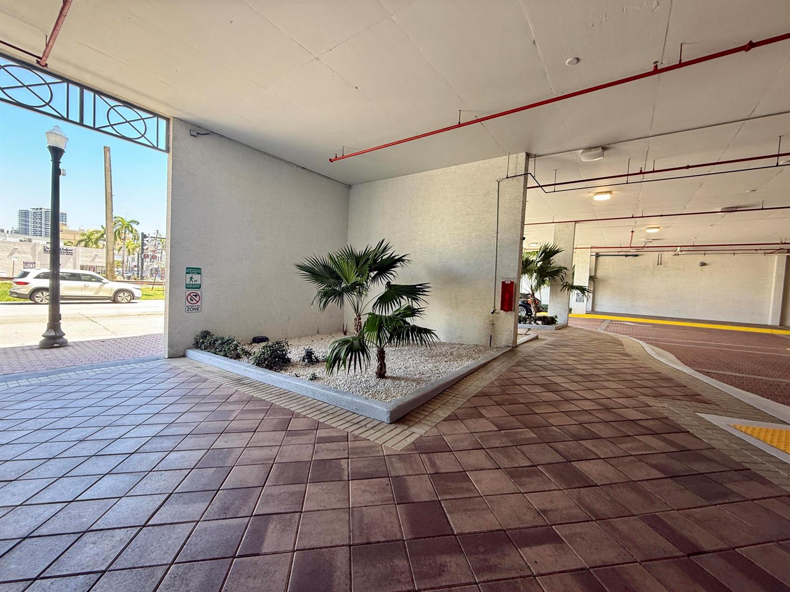 A covered parking area features a landscaped planter with a small palm tree — 140 S Dixie Highway # 813, Hollywood FL 33020, HOLLYWOOD, FL