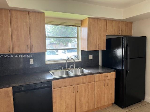 A kitchen features light wood cabinets, a black refrigerator, a dishwasher, and a window — 7350 SW 82nd St # C125, Miami FL 33143, MIAMI, FL