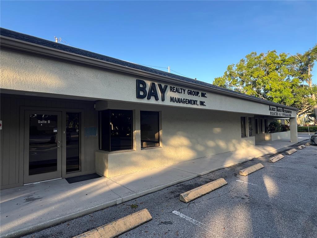 An exterior view of a single-story commercial building with a parking lot in front — 32502 US HIGHWAY 19 N UNIT B, PALM HARBOR, FL