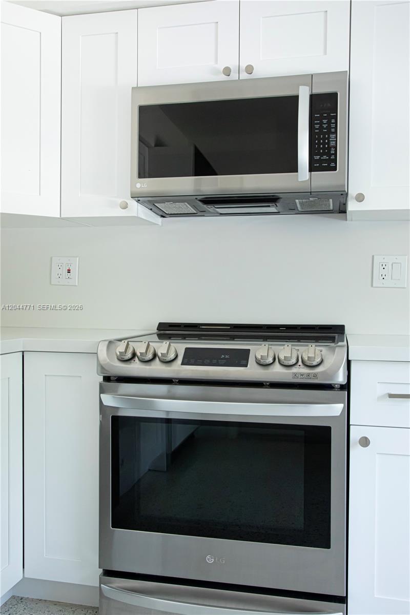 A stainless steel LG microwave and range are installed between white kitchen cabinets — 1226 SW 30th Ave # 1226, Miami FL 33135, MIAMI, FL
