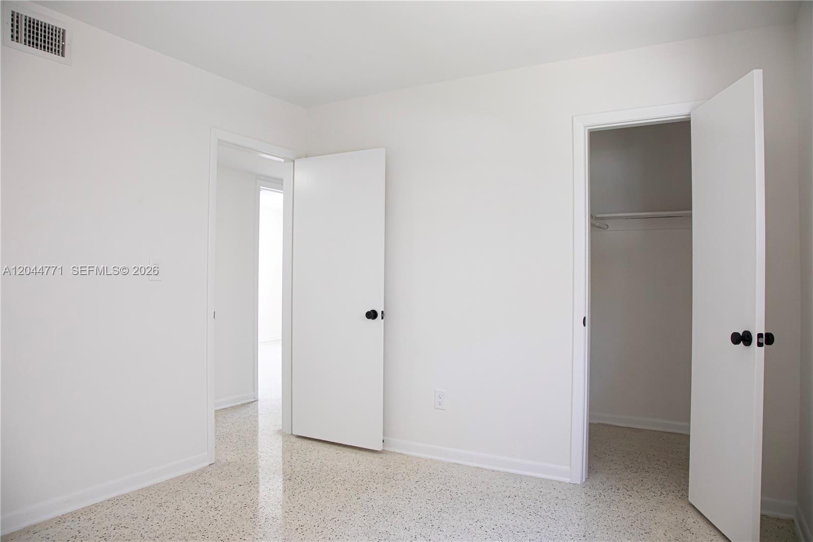 A sparsely furnished room features white walls, a closet, and light-colored speckled flooring — 1226 SW 30th Ave # 1226, Miami FL 33135, MIAMI, FL