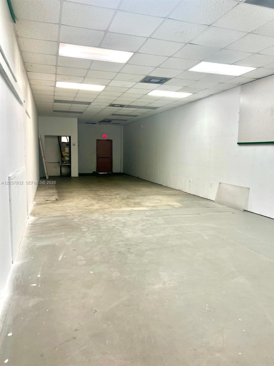 This is an empty commercial space with a drop ceiling, fluorescent lighting, and concrete floors — 11710 NW South River Dr, Medley FL 33178, MEDLEY, FL