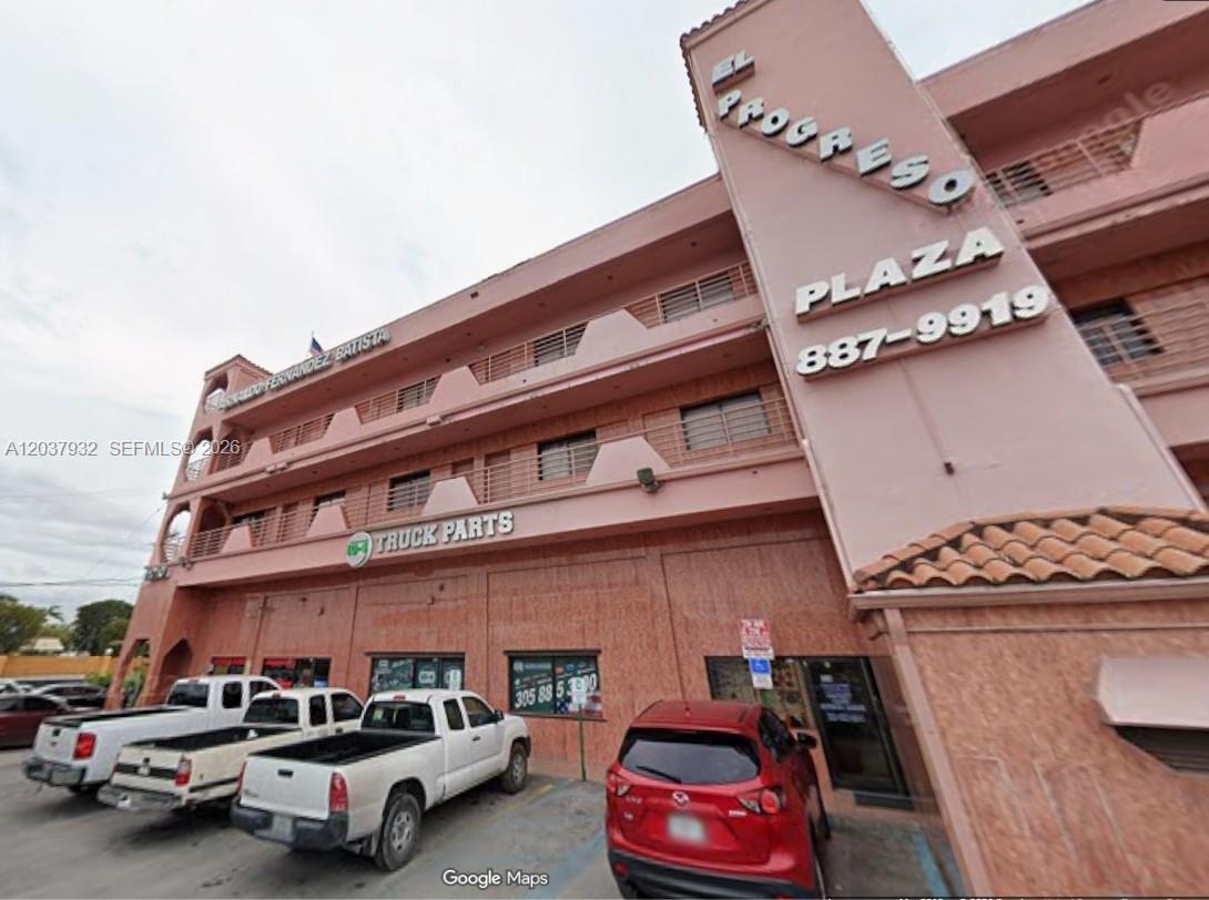 A pink multi-story commercial building with a truck parts store and parking lot — 11710 NW South River Dr, Medley FL 33178, MEDLEY, FL