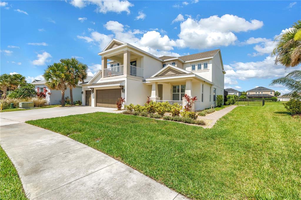 A two-story house with a beige exterior, a two-car garage, and a front porch — 10108 CORRIENTE COURT, PALMETTO, FL