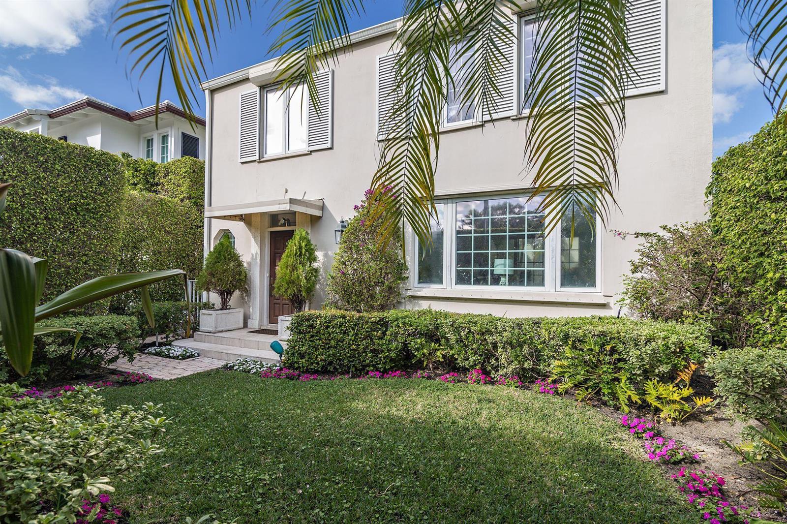 A bright living room features a beige sofa, glass coffee tables, and glass patio doors — 155 Peruvian Avenue, Palm Beach FL 33480, PALM BEACH, FL
