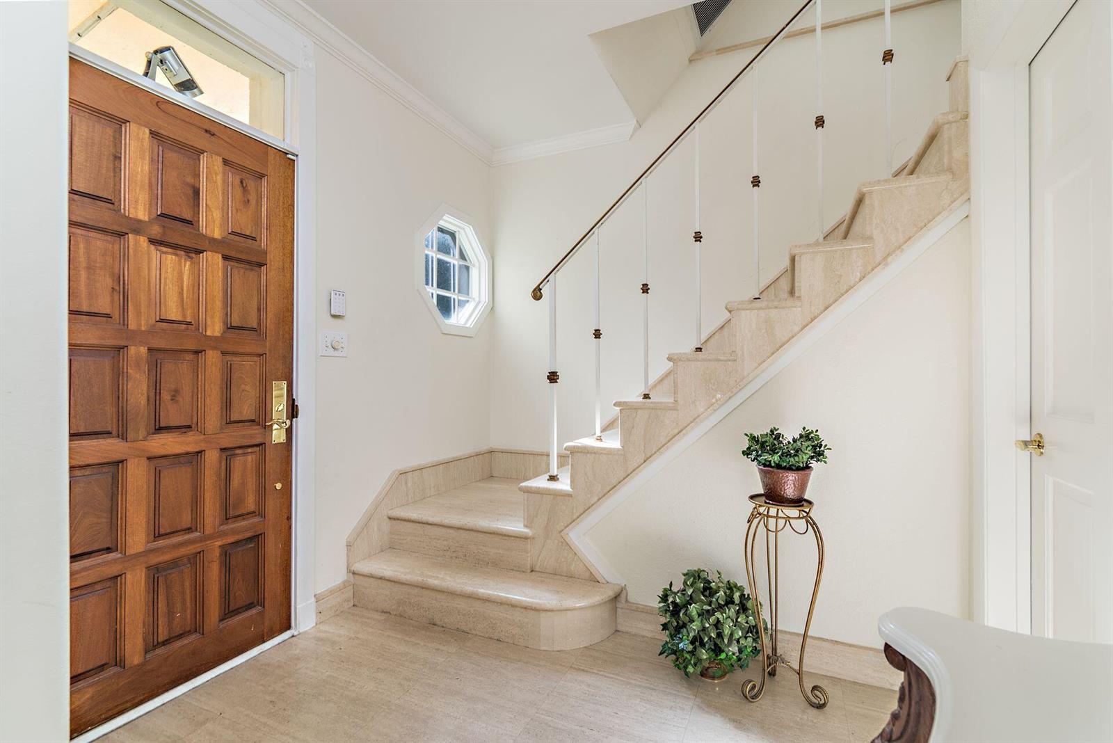 A bright living room features two beige sofas, rattan chairs, and large windows with curtains — 155 Peruvian Avenue, Palm Beach FL 33480, PALM BEACH, FL