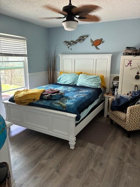 A bedroom features a white bed frame, light blue walls, and wood-look flooring — 849 HAPPINESS AVENUE SW, PALM BAY, FL