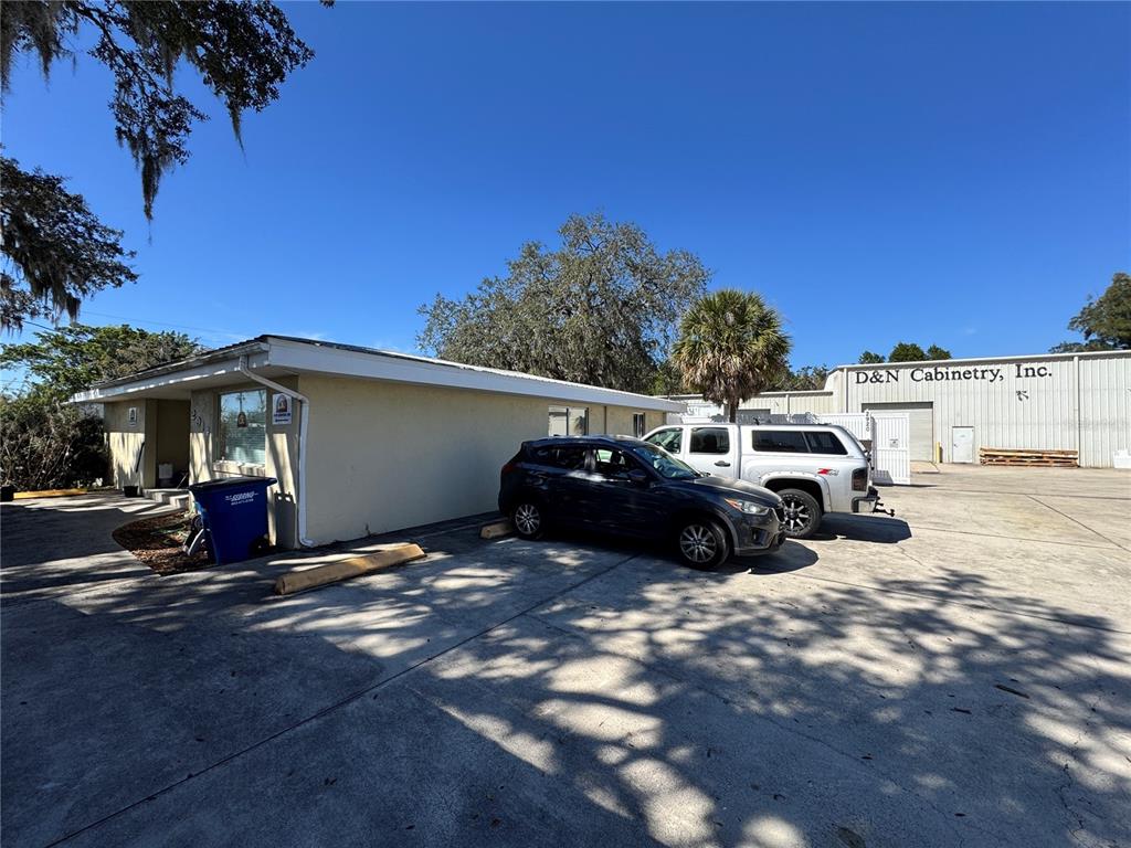 A tan commercial building with a parking lot and a nearby cabinetry business — 2914-A KENILWORTH BOULEVARD, SEBRING, FL