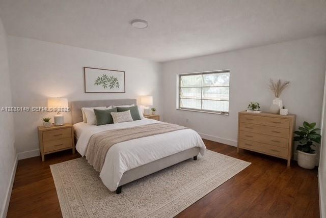 A bedroom features a bed with a white comforter, two nightstands, and a wooden dresser — 6875 NW 4th Ave, Miami FL 33150, MIAMI, FL