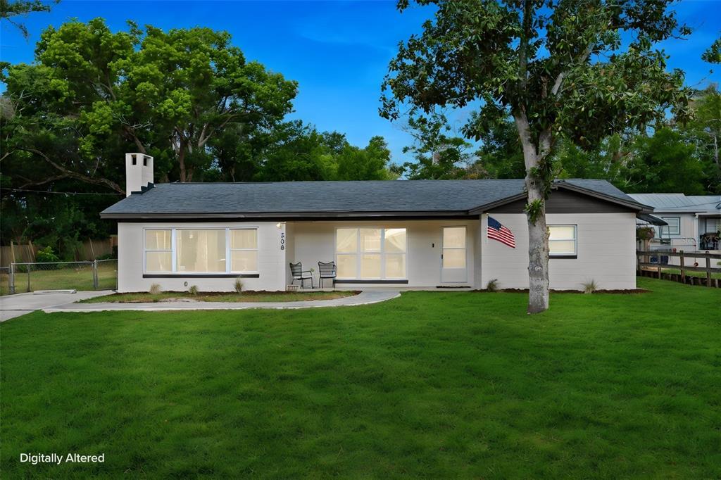A single-story house with a white exterior, dark roof, and a front lawn — 508 OHIO BOULEVARD, EUSTIS, FL