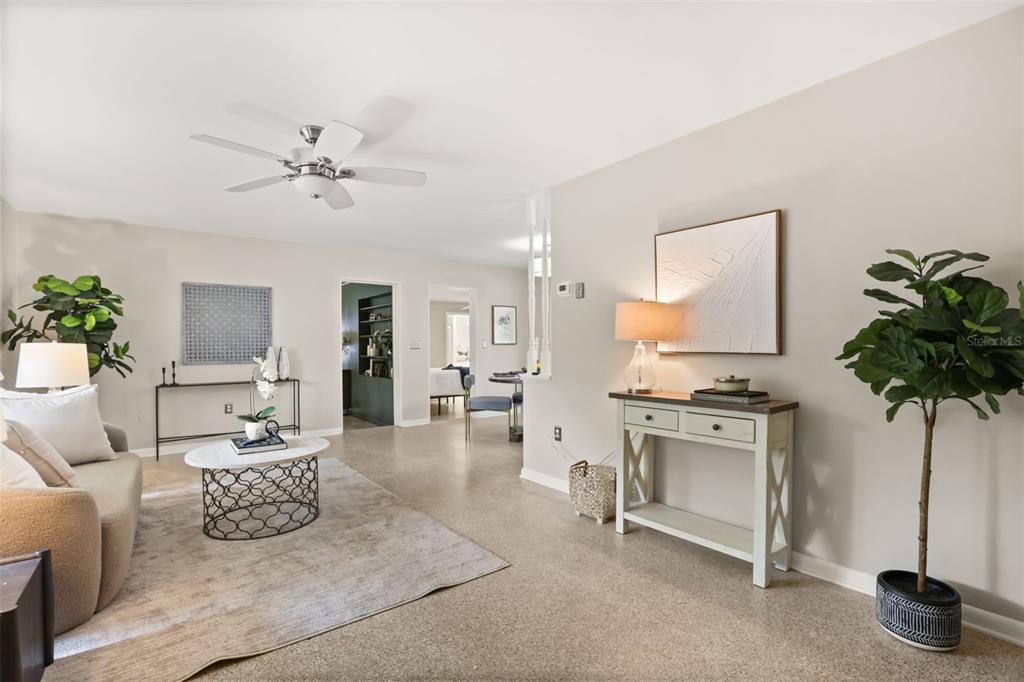 A living room features a beige sofa, a round coffee table, and a console table — 508 OHIO BOULEVARD, EUSTIS, FL
