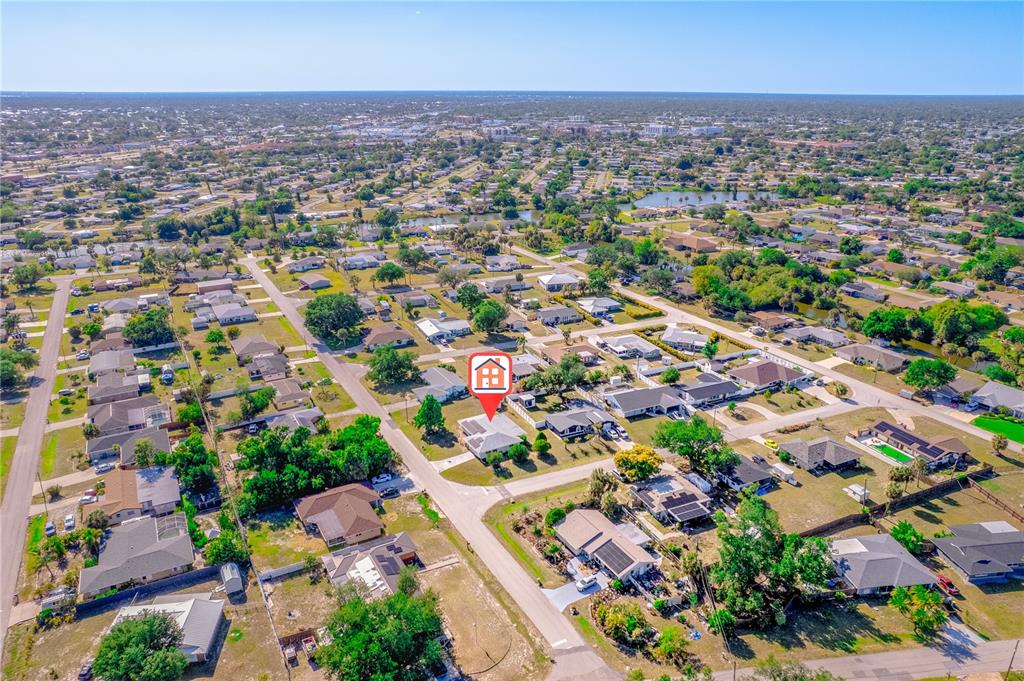 An aerial view of a residential neighborhood featuring a house marked with a red icon — 22158 RIVERHEAD AVENUE, PORT CHARLOTTE, FL