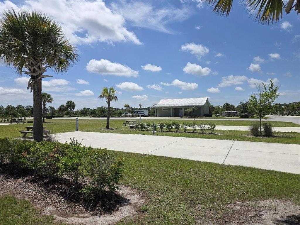 A paved RV site with a picnic table and a small building in the background — HIGHWAY 630  E UNIT 44, LAKE WALES, FL
