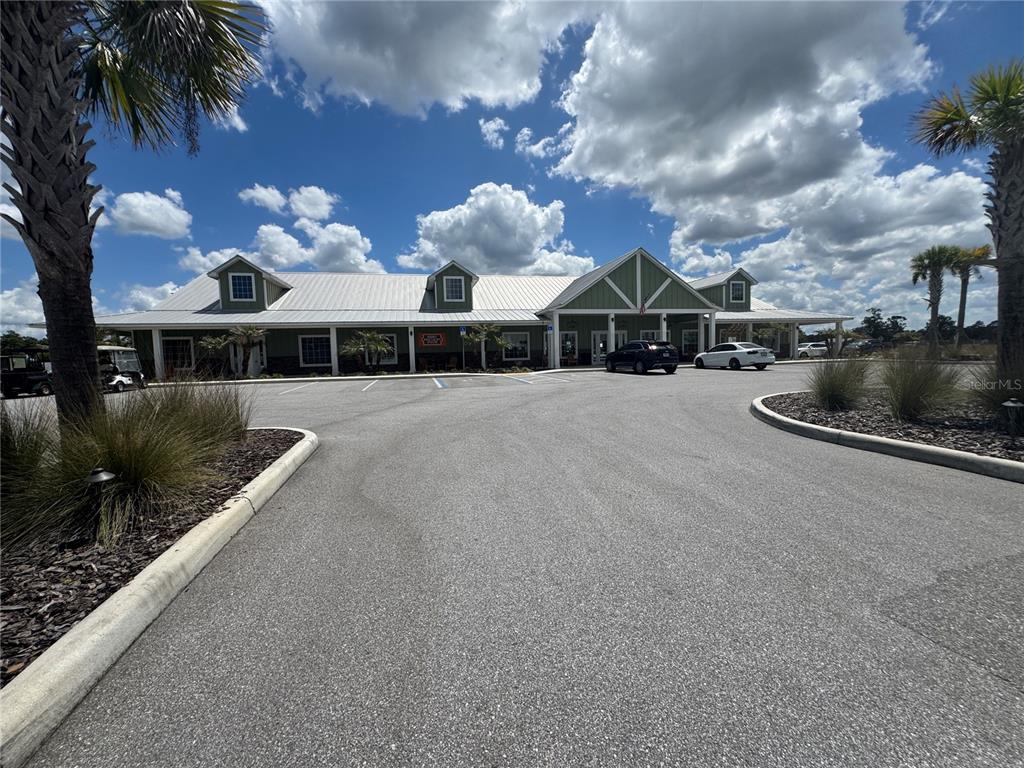 A single-story building with a metal roof and green siding sits behind a parking lot — HIGHWAY 630  E UNIT 44, LAKE WALES, FL
