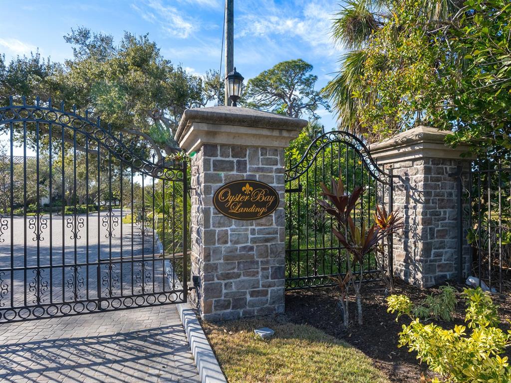 An aerial view shows waterfront homes surrounded by lush trees along a coastal bay — 1404 KENILWORTH STREET, SARASOTA, FL