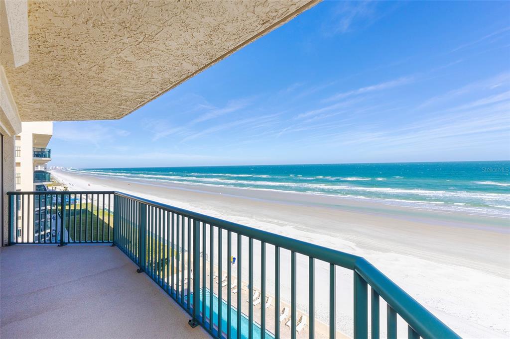 A balcony with a metal railing overlooks a sandy beach and the ocean — 4631 S ATLANTIC AVENUE UNIT 8601, PONCE INLET, FL