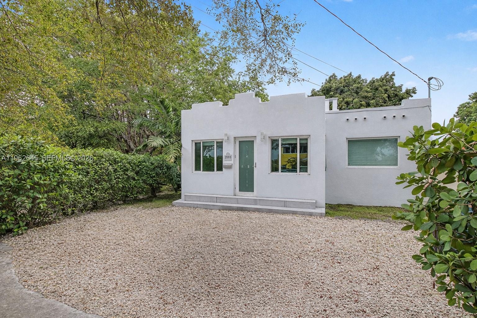 A white, single-story house with a gravel driveway and a stepped parapet roofline — 2900 SW 4th St, Miami FL 33135, MIAMI, FL